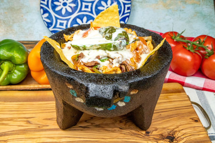 La Herradura molcajete filled with grilled meats and vegetables